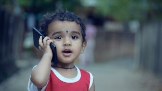 toddler answering cell phone